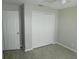 Bedroom features a double door closet and light colored vinyl flooring at 2114 Intervista Ln, Valrico, FL 33594