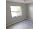 A bright bedroom featuring wood-look floors and a large window at 2114 Intervista Ln, Valrico, FL 33594