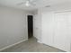Bedroom featuring a closet, a light colored ceiling fan, and light colored vinyl flooring at 2114 Intervista Ln, Valrico, FL 33594