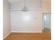 Dining room with wood flooring, neutral walls, and modern light fixture at 2114 Intervista Ln, Valrico, FL 33594