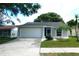 Charming single-story home featuring an attached garage, well-manicured lawn, and inviting curb appeal at 2114 Intervista Ln, Valrico, FL 33594