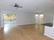 Spacious living room featuring hardwood floors, ample natural light, and a ceiling fan at 2114 Intervista Ln, Valrico, FL 33594