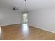 Open living space with hardwood floors, featuring sliding door access to the outdoors and contemporary ceiling fans at 2114 Intervista Ln, Valrico, FL 33594
