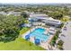 Bird's eye view of a community pool area featuring lap lanes, splash pad, and sunbathing areas at 2320 Harn Blvd, Clearwater, FL 33764