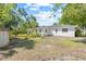 Spacious backyard showcasing the home's rear facade surrounded by greenery, bushes and some perimeter landscaping at 2320 Harn Blvd, Clearwater, FL 33764
