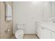 Clean bathroom with a white vanity, a toilet, and tiled walls at 2320 Harn Blvd, Clearwater, FL 33764