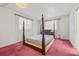 Bright bedroom featuring reddish carpet and natural light from two windows at 2320 Harn Blvd, Clearwater, FL 33764