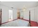 Spacious bedroom with a four-post bed and easy access to the closet and bathroom at 2320 Harn Blvd, Clearwater, FL 33764