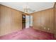 Bedroom featuring wood paneled walls and a view to the hallway at 2320 Harn Blvd, Clearwater, FL 33764