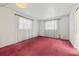 Simple bedroom with reddish carpet and white walls under a decorative light at 2320 Harn Blvd, Clearwater, FL 33764