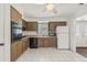 Spacious kitchen with white tile, wood cabinets, and view to the front entrance at 2320 Harn Blvd, Clearwater, FL 33764