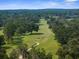 Breathtaking aerial view showcasing a lush green golf course surrounded by mature trees at 23327 Christian Cir, Brooksville, FL 34601