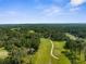 Scenic aerial view of a lush landscape, complemented by a sprawling golf course and mature trees under a clear blue sky at 23327 Christian Cir, Brooksville, FL 34601