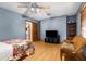 Spacious bedroom with a ceiling fan, television, and easy access to the ensuite bathroom at 23327 Christian Cir, Brooksville, FL 34601