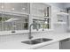 Close-up of the modern kitchen featuring sleek countertops and a stainless steel sink at 23327 Christian Cir, Brooksville, FL 34601