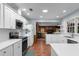 Bright and airy kitchen featuring white cabinets, modern appliances, and views into the living room at 23327 Christian Cir, Brooksville, FL 34601