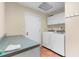 Convenient laundry room with white cabinets, spacious countertop, and full-size washer and dryer at 23327 Christian Cir, Brooksville, FL 34601