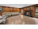 Comfortable living room featuring wood paneling, a fireplace, and plush seating at 23327 Christian Cir, Brooksville, FL 34601