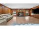 Spacious living room featuring a cozy fireplace, wood paneling, and ample natural light at 23327 Christian Cir, Brooksville, FL 34601
