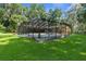Beautiful in-ground pool surrounded by a screened enclosure that allows enjoyment of the outdoors with few pests at 23327 Christian Cir, Brooksville, FL 34601