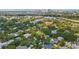 Overhead drone shot of a neighborhood covered in lush trees with a cityscape in the background at 2512 W Jetton Ave, Tampa, FL 33629
