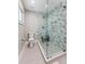 Bathroom with a large, patterned glass enclosed shower and modern fixtures at 2512 W Jetton Ave, Tampa, FL 33629