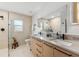 Bright bathroom showcasing a double vanity with black fixtures and a large mirror above at 2512 W Jetton Ave, Tampa, FL 33629
