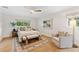 Cozy bedroom featuring a queen bed, bench, sitting chair, and natural light at 2512 W Jetton Ave, Tampa, FL 33629