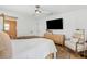 Cozy bedroom features wood floors, a ceiling fan, and ample closet space at 2512 W Jetton Ave, Tampa, FL 33629