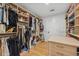 Walk-in closet with custom shelving, hanging rods, and dresser storage for clothes and accessories at 2512 W Jetton Ave, Tampa, FL 33629