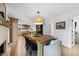 Dining area with a large wood table, modern lighting, and a view of the adjacent kitchen at 2512 W Jetton Ave, Tampa, FL 33629