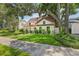 Charming home boasts a lush green lawn and mature tree, offering classic appeal and inviting curb appeal at 2512 W Jetton Ave, Tampa, FL 33629