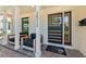 Inviting front porch with comfortable seating and a stylish modern door with a brick surround and pillars at 2512 W Jetton Ave, Tampa, FL 33629