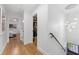 Hallway with hardwood floors leads to a bedroom, bathroom, and stairs at 2512 W Jetton Ave, Tampa, FL 33629
