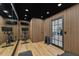 Home gym with exercise bike, weights, wood paneled walls, and ample natural light at 2512 W Jetton Ave, Tampa, FL 33629