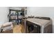 Well-organized laundry room with modern washer, dryer, and storage shelving at 2512 W Jetton Ave, Tampa, FL 33629
