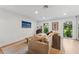 Bright living room features neutral tones, wood floors, and natural light from large windows at 2512 W Jetton Ave, Tampa, FL 33629