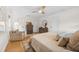 Bright main bedroom features hardwood floors, ceiling fan, and a comfortable sitting area at 2512 W Jetton Ave, Tampa, FL 33629