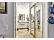 Bathroom view featuring double mirrored closet doors and a full bathroom in the background at 269 Los Prados Dr # 1011, Safety Harbor, FL 34695