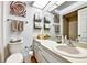 Bright bathroom featuring modern fixtures, decorative art, and ample storage for a clean and organized space at 269 Los Prados Dr # 1011, Safety Harbor, FL 34695