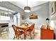Cozy dining room with wooden furniture, a rustic light fixture, and charming wall decor at 269 Los Prados Dr # 1011, Safety Harbor, FL 34695