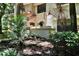 Condo exterior showcases a landscaped front yard with a private patio and lush greenery at 269 Los Prados Dr # 1011, Safety Harbor, FL 34695