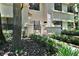 Charming condo exterior with a private patio, lush landscaping, and manicured lawn at 269 Los Prados Dr # 1011, Safety Harbor, FL 34695