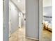 Inviting hallway with neutral tones and tile flooring leads to the bathroom and bedroom at 269 Los Prados Dr # 1011, Safety Harbor, FL 34695