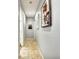 Hallway featuring art and Gathering photos, tiled floor, and neutral paint to create a welcoming atmosphere at 269 Los Prados Dr # 1011, Safety Harbor, FL 34695