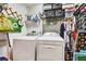 Organized laundry room with a washer, dryer, shelving, and storage for convenience at 269 Los Prados Dr # 1011, Safety Harbor, FL 34695