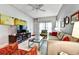 Cozy living room featuring a sofa, a glass coffee table, and a large television for entertainment at 269 Los Prados Dr # 1011, Safety Harbor, FL 34695