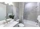 Elegant bathroom boasting a combination tub/shower with stylish tile and a pristine white vanity at 27124 Capri Shores Cir, Englewood, FL 34223