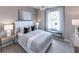 Comfortable bedroom with a white headboard bed, stylish decor, and lots of natural light at 27124 Capri Shores Cir, Englewood, FL 34223