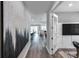 Spacious hallway leads to living areas, showcasing modern artwork and natural light at 27124 Capri Shores Cir, Englewood, FL 34223